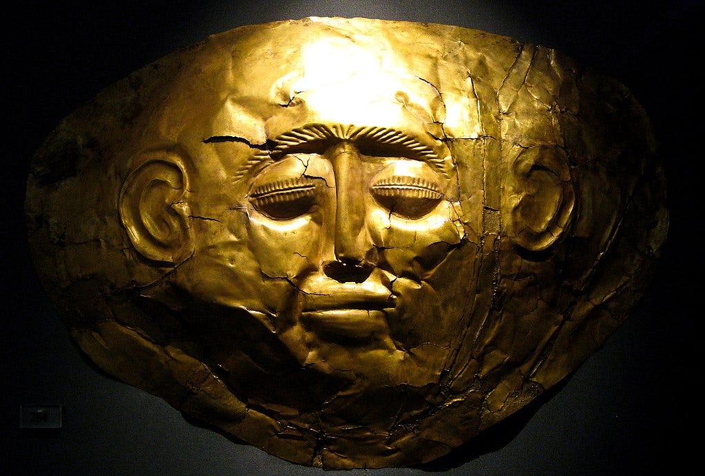 a dramatic spotlit photo of a gold mycenaean death mask