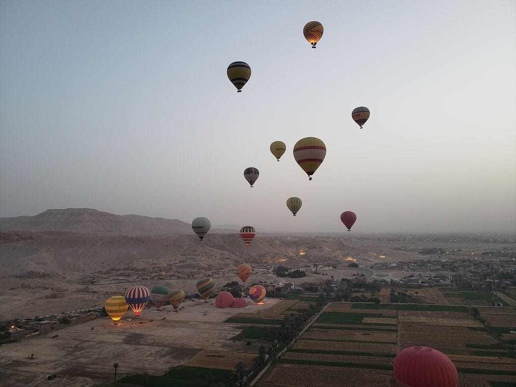 Air ballons saoring over Valley of the Kings in Luxor Egpyt