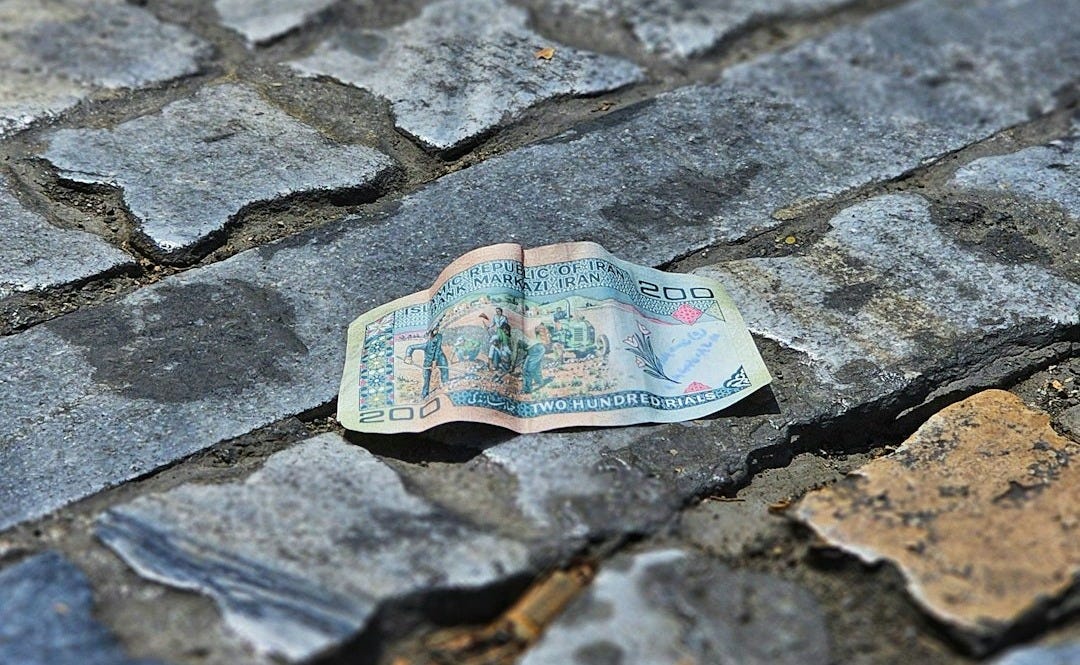 A piece of paper sitting on top of a cobblestone road