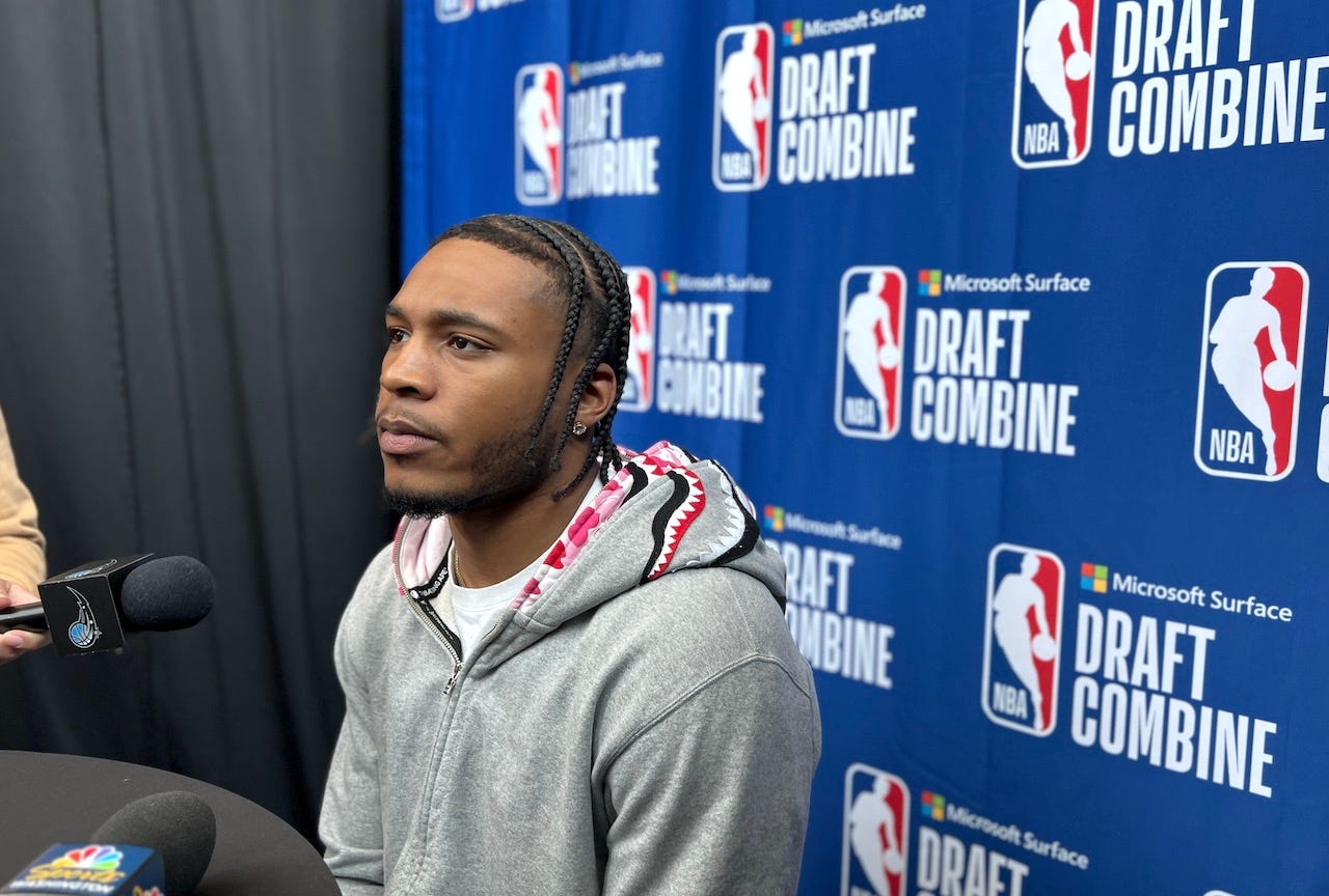 Cam Whitmore, wearing a gray zip hoodie, talks with reporters at the 2023 NBA Draft Combine.
