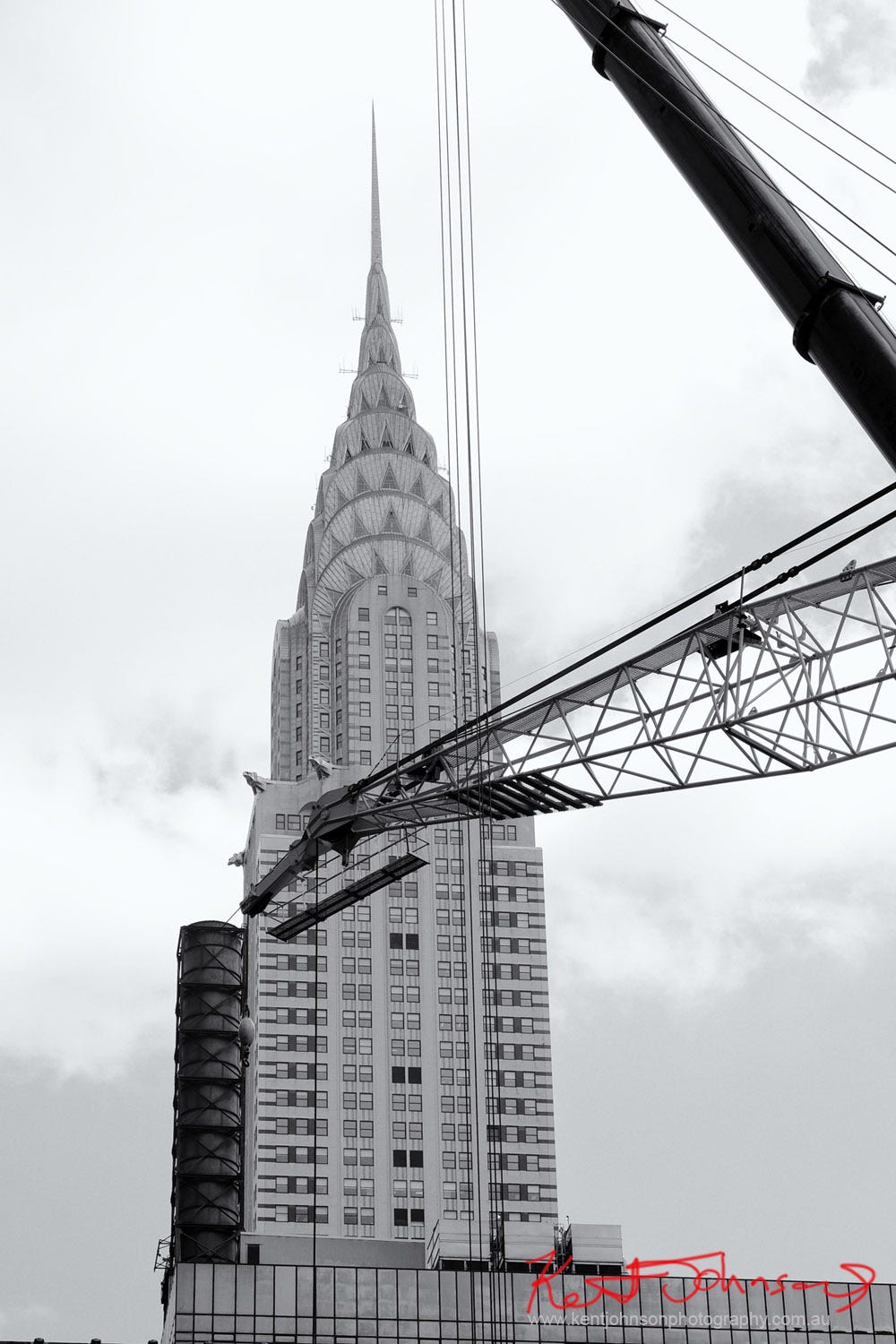 Black and white photograph of The Chrysler Building with the boom of a construction crane in the foregound, NYC 2017. Photograph by Kent Johnson
