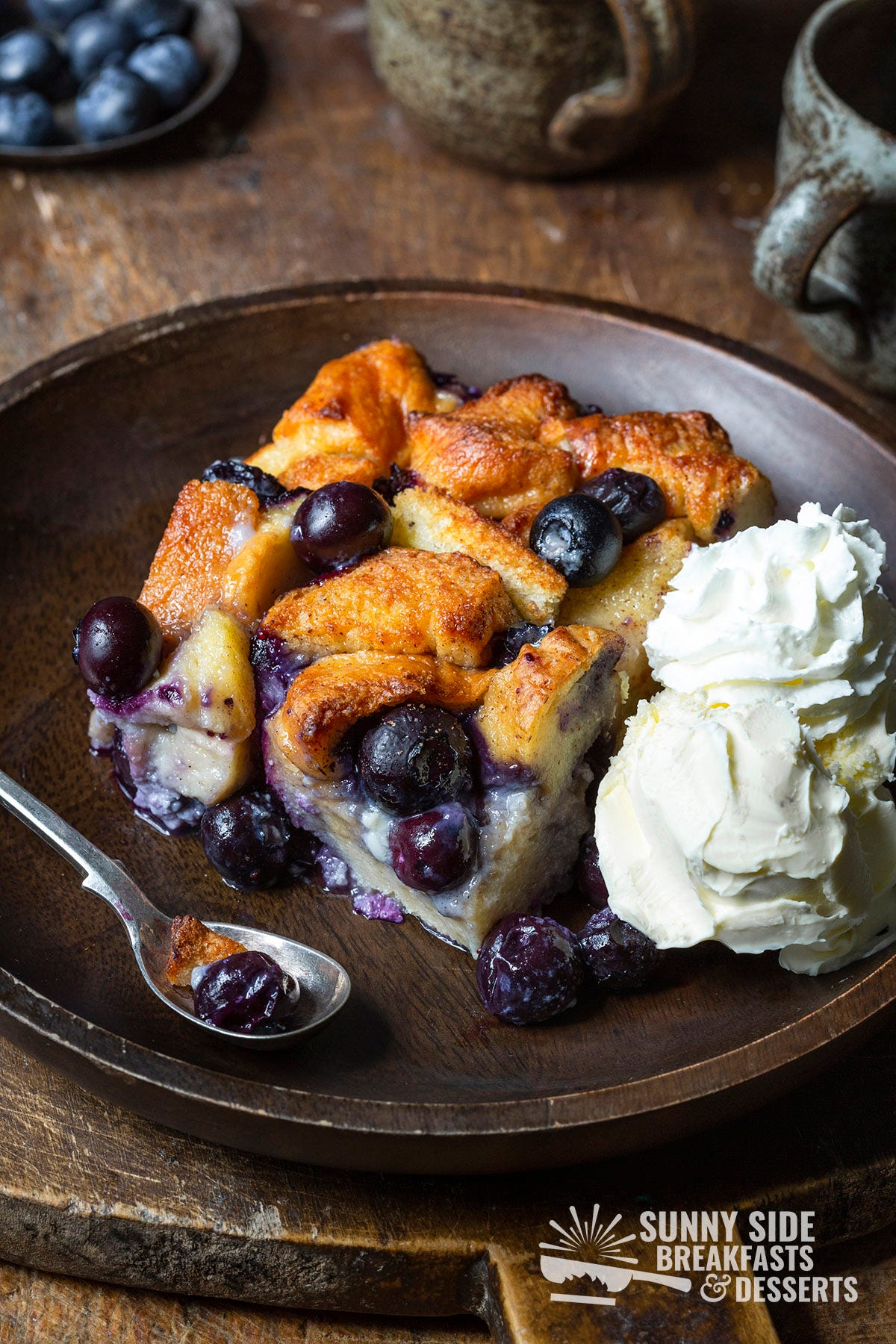 A slice of bread pudding with whipped cream.