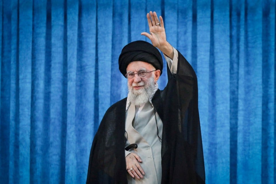 Ayatollah Ali Khamenei waving.