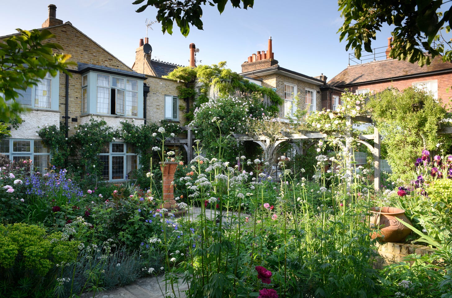 a pretty cottage garden with climbing roses