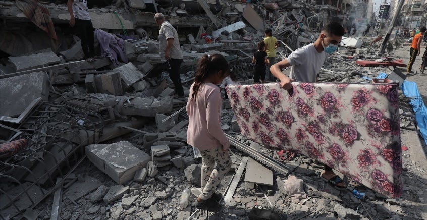 Photo of a young girl looking through the rubble of destroyed buildings in Gaza. Palestinian News & Information Agency (Wafa) in contract with APAimages, licensed under CC BY-SA 3.0 DEED