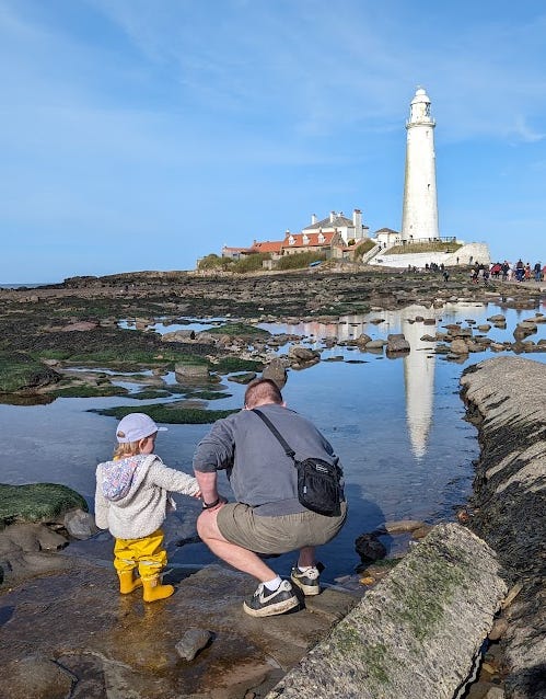 Craig and Miri at the lighthouse looking in the rock pools