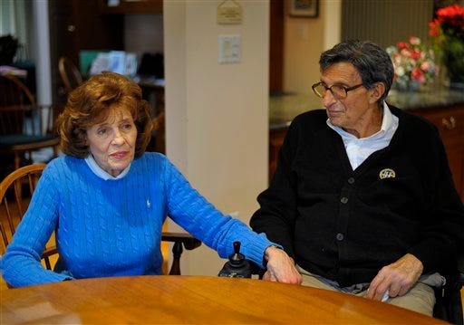 In this photo taken Jan. 12, 2012, Susan Paterno, left, sits with her husband, former Penn State football coach Joe Paterno as he is interviewed at his home in State College, Pa. In his first public comments since being fired two months ago, Paterno told The Washington Post he "didn't know which way to go" after an assistant coach came to him in 2002 saying he had seen retired defensive coordinator Jerry Sandusky sexually abusing a boy.
