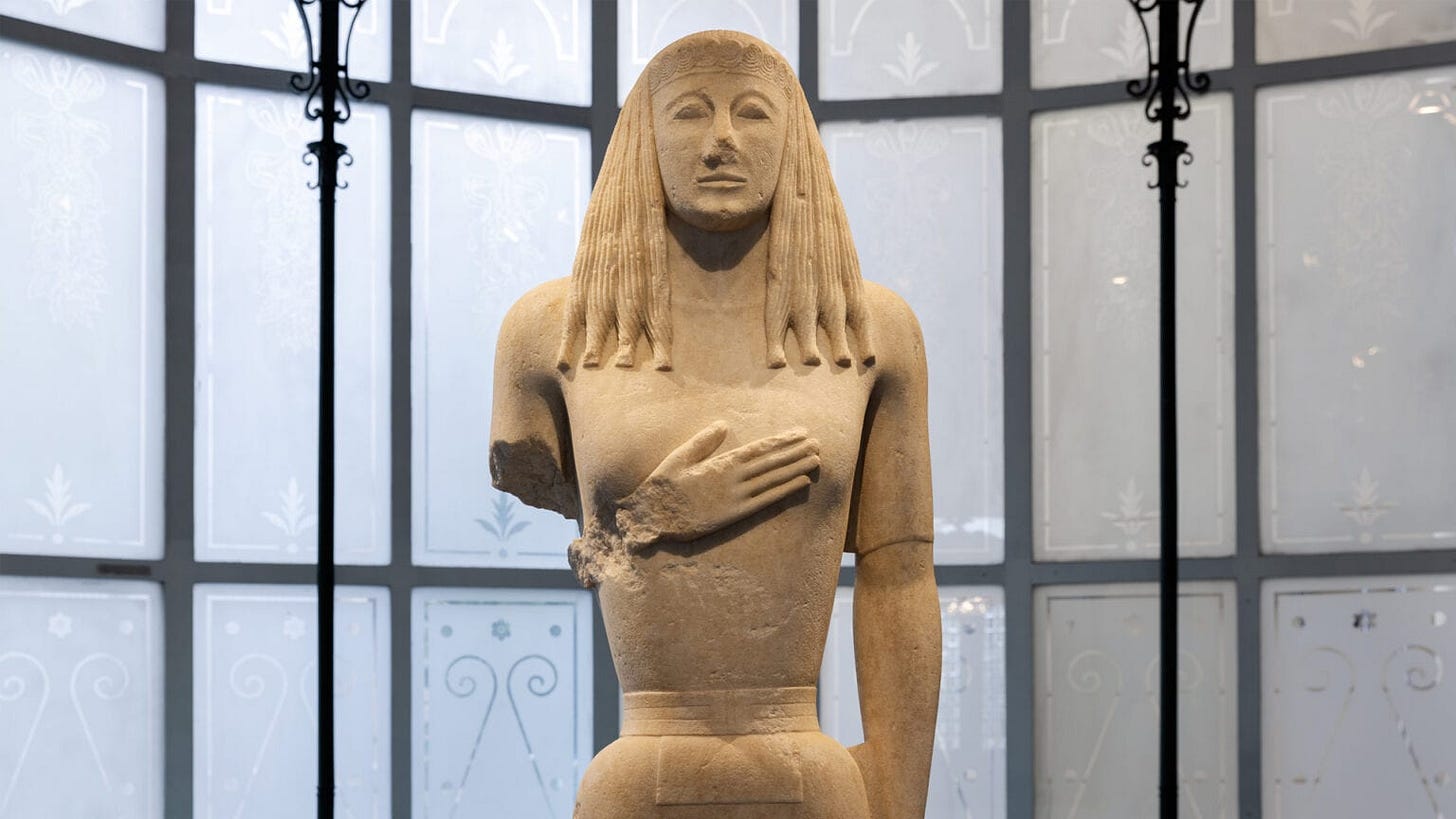 Marble colossal statue of a kore from Thera, 600-575 BC (?) in the Museum of Cycladic Art, Athens. Photo by Paris Tavitian © Museum of Cycladic Art. From http://cycladic.gr/.