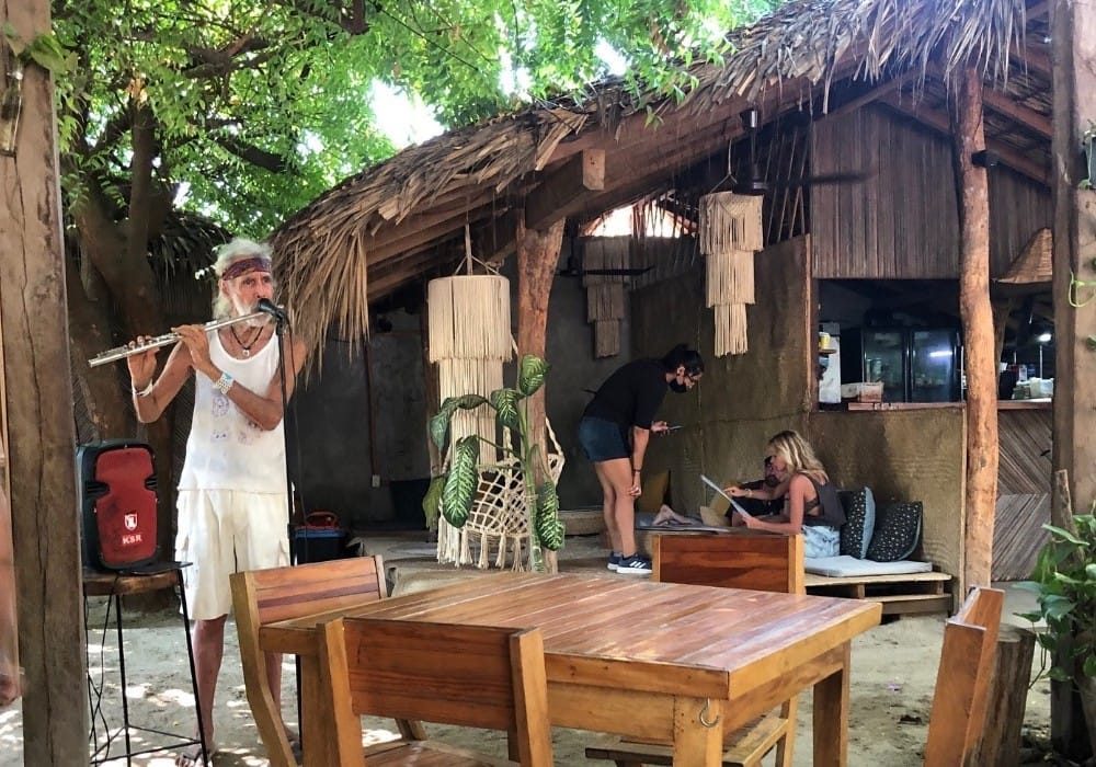 Flute player in a cafe serving high vibration food in Puerto Escondido, Oaxaca