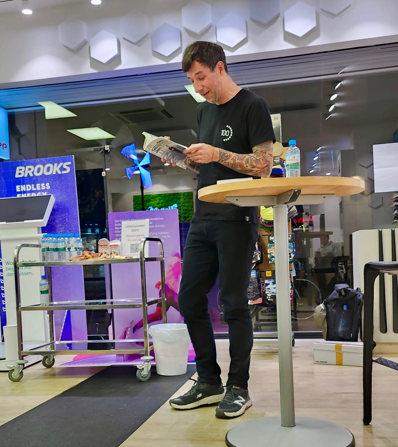 The author standing in a running store reading from his  book