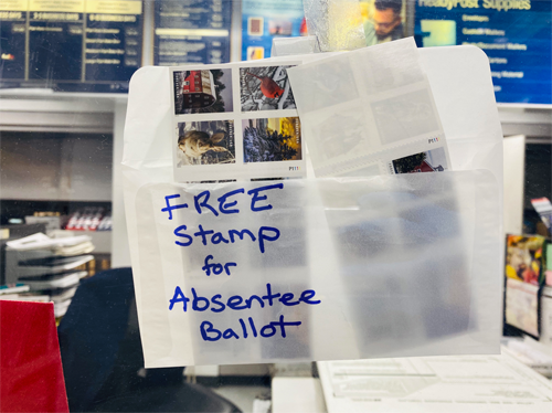 Thank You, USPS and Good Neighbors (photo) photo, post office 2020, envelope with handwritten text: "free stamp for absentee ballot"
