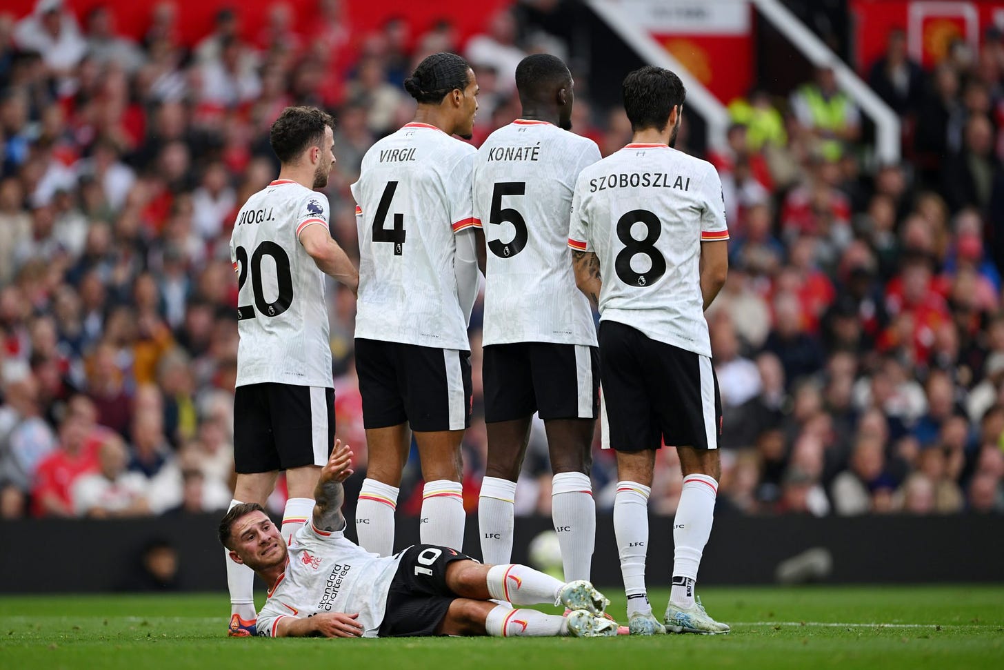 Alexis Mac Allister of Liverpool lays on the ground, behind (L-R) Diogo Jota, Virgil van Dijk, Ibrahima Konate and Dominik Szoboszlai of Liverpool ...