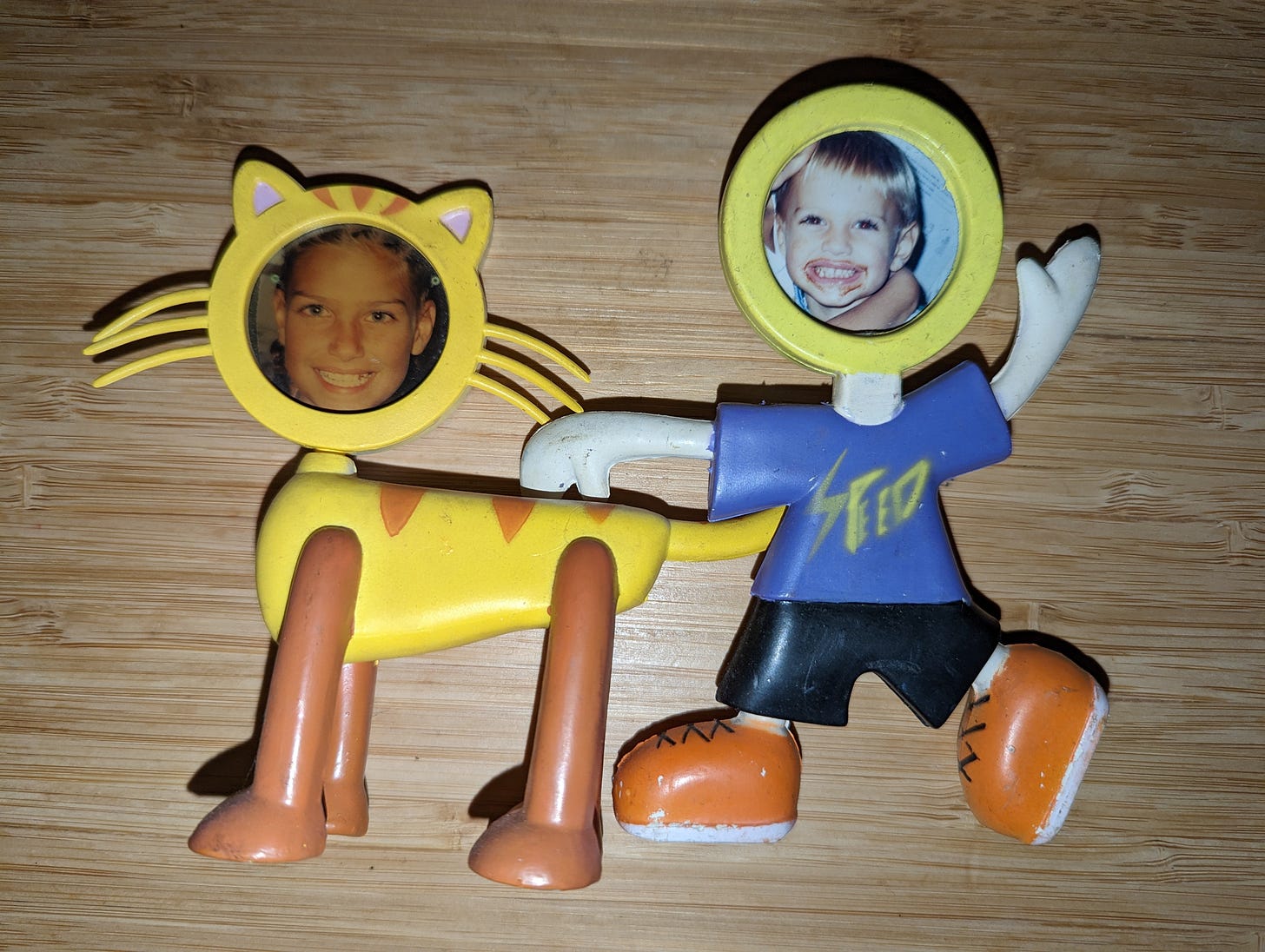 sister and brother in picture frames of a cat and a boy running 