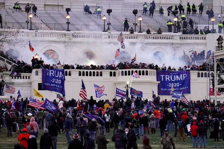 Trump 2020 signs hang in front of the Capitol Building.