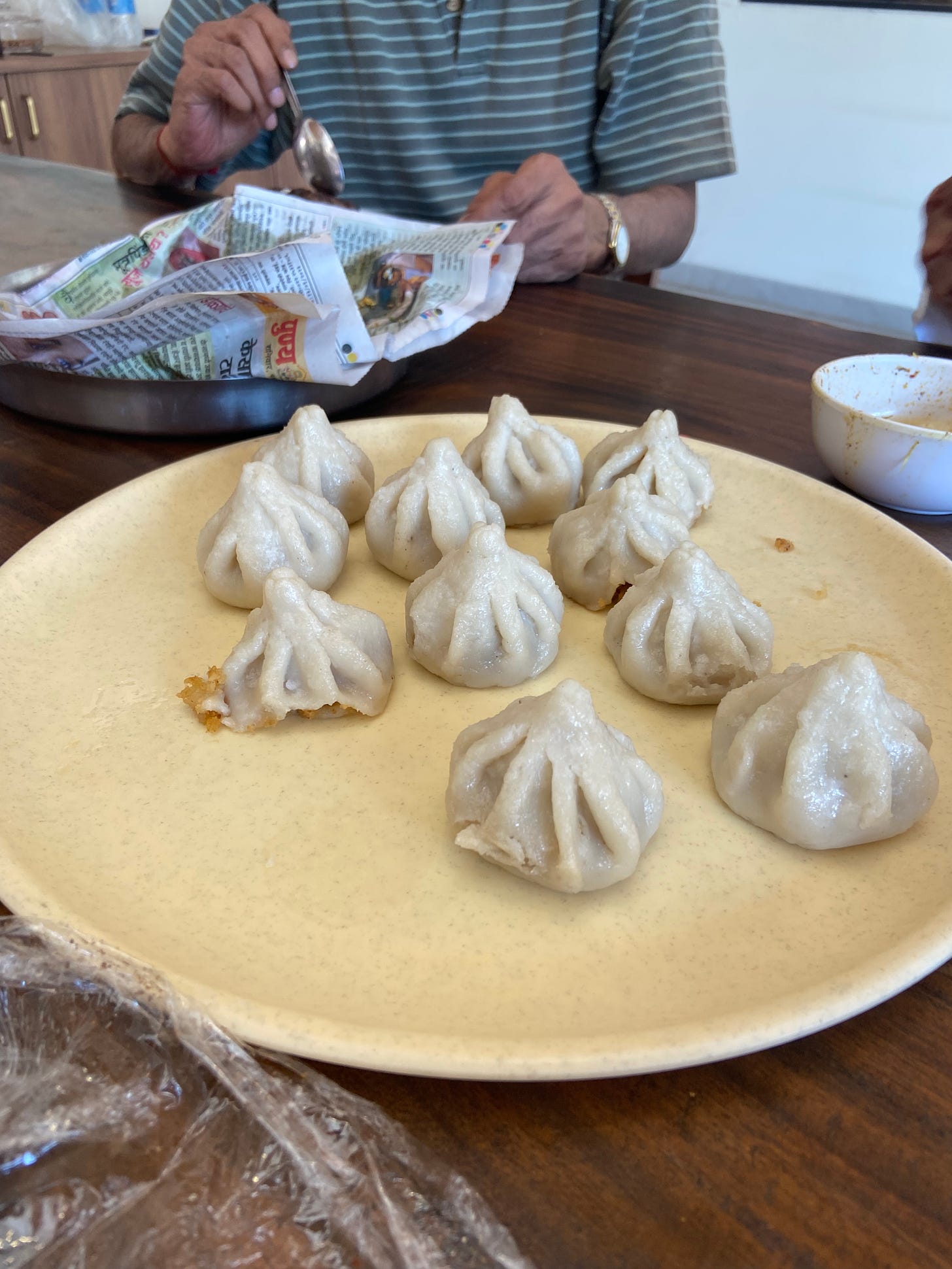 A photo of a light yellow plate filled with modaks