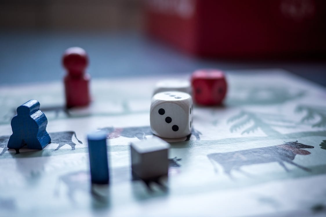 Free Dices and Wooden Pieces on Game Board Stock Photo