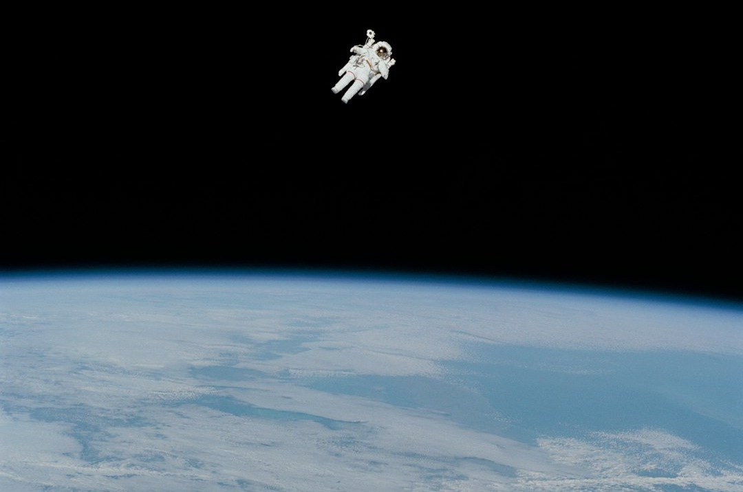 astronaut in spacesuit floating in space