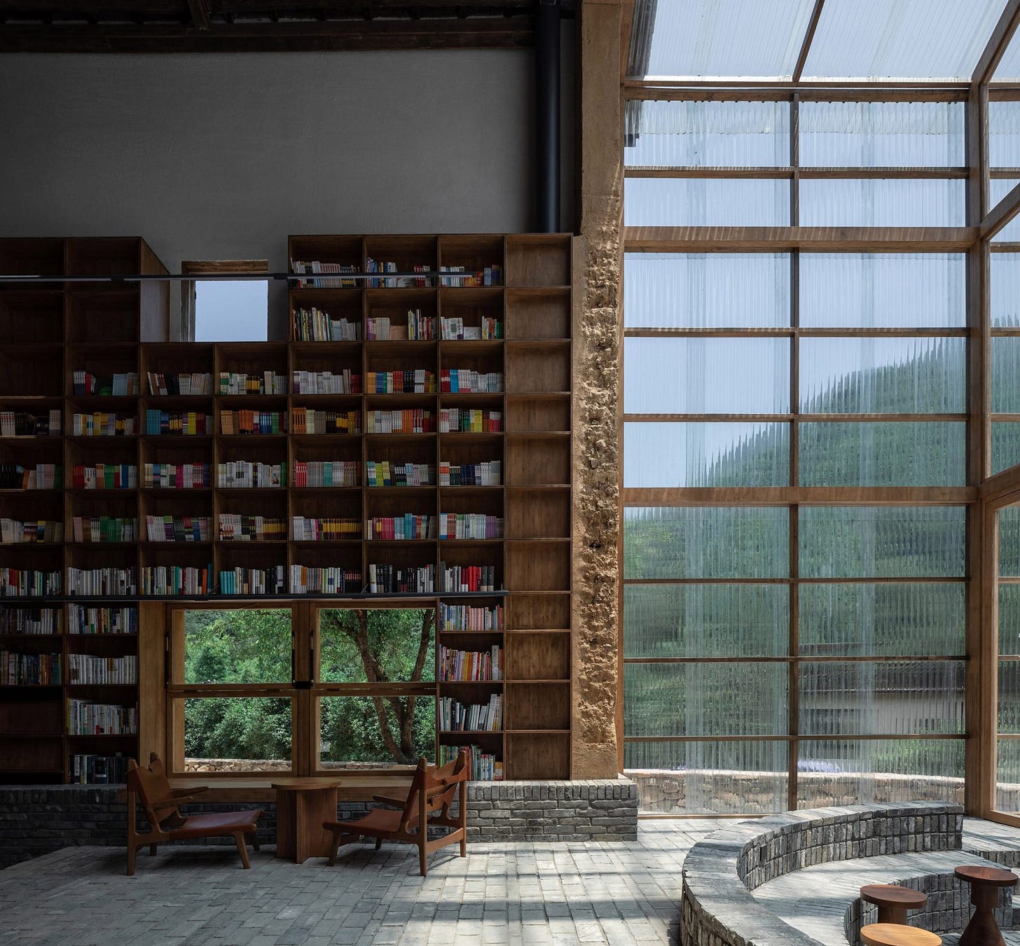 Atelier Tao+C lines walls of capsule hotel with bamboo bookshelves