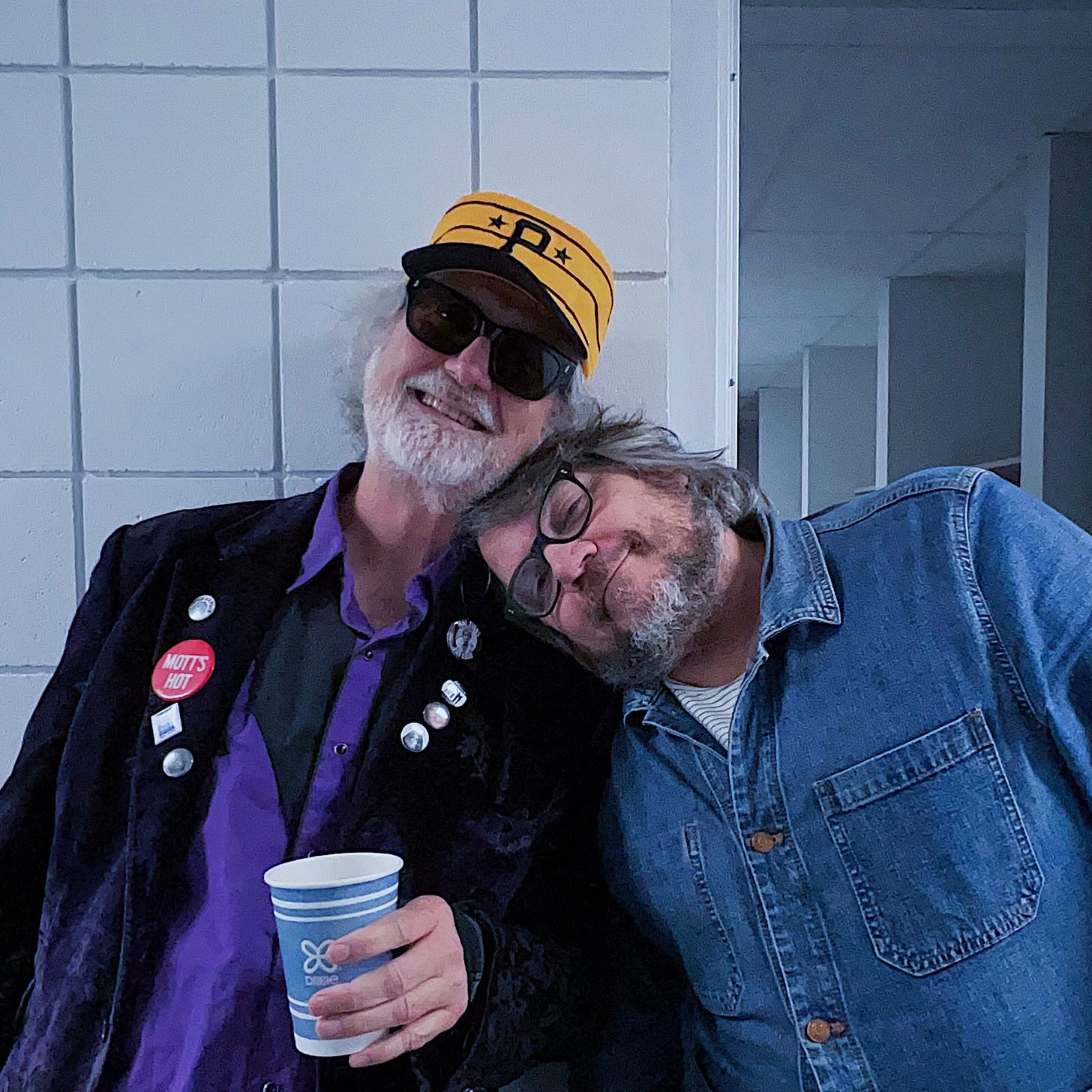 Jeff rests his head on Scott McCaughey’s shoulder, both smiling