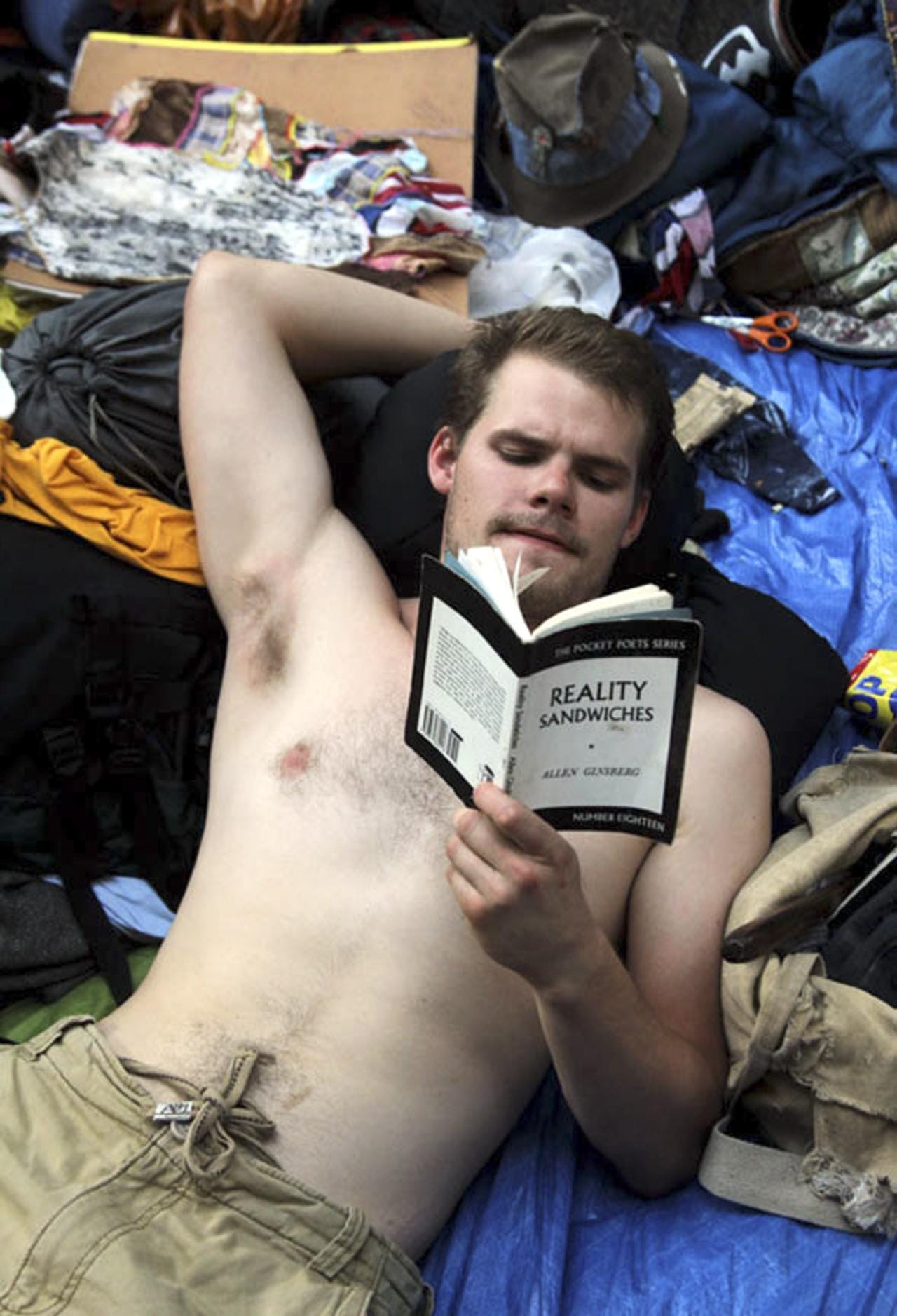 Dylan Spoelstra from Toronto, Ontario, reads Allen Ginsberg's "Reality Sandwiches" at  Zuccotti Park during Occupy Wall Street protests.