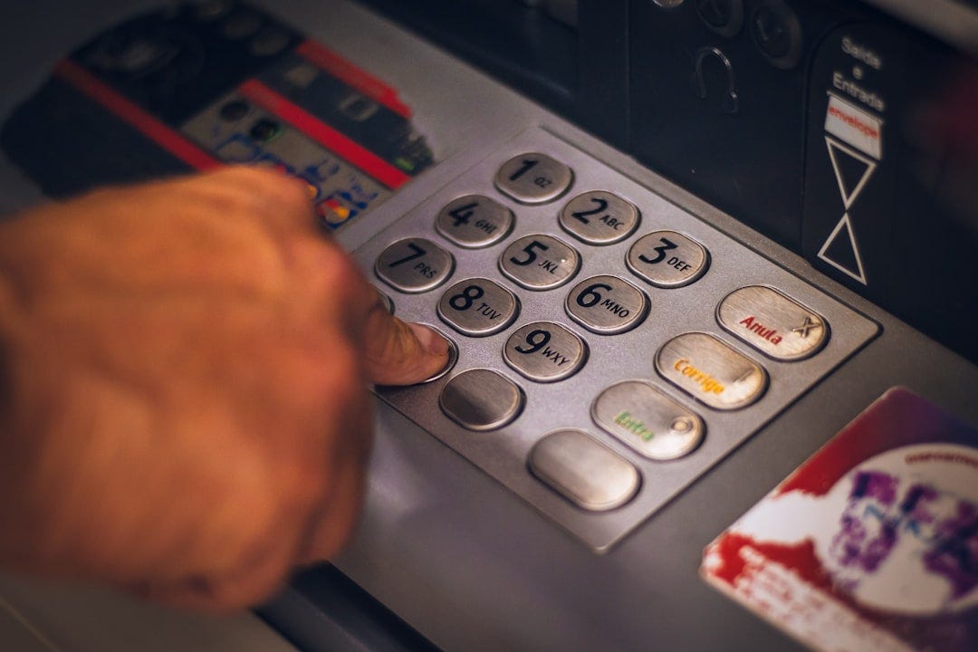 Using a ATM - Hand pressing number Using a ATM - Hand pressing number