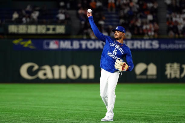 Mookie Betts of the Los Angeles Dodgers warms-up in the outfield prior to the game between the Los Angeles Dodgers and the Yomiuri Giants at Tokyo...