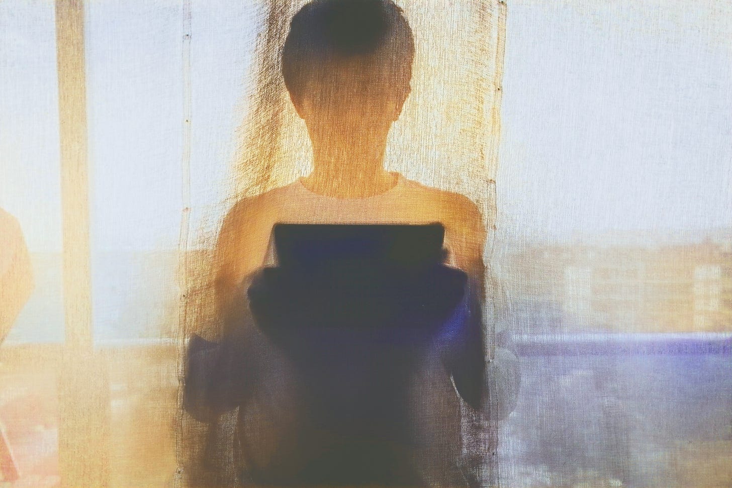 A silhouette is hiding behind the curtains, with a tablet on their hands.