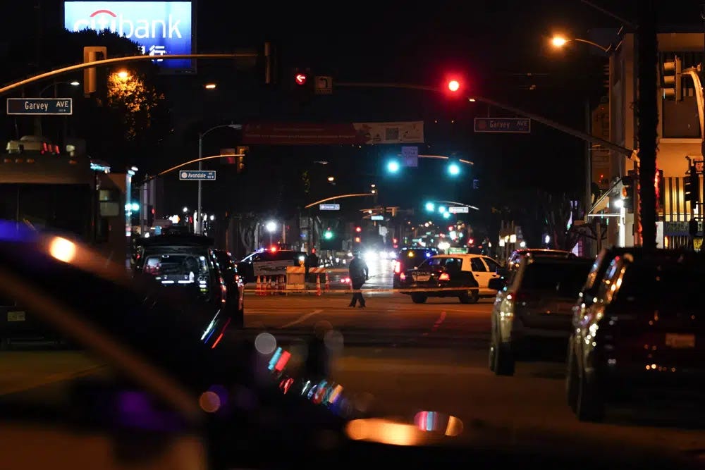 Police investigate a scene where a shooting took place in Monterey Park, Calif., Sunday, Jan. 22, 2023. Dozens of police officers responded to reports of a shooting that occurred after a large Lunar New Year celebration had ended in a community east of Los Angeles late Saturday. (AP Photo/Jae C. Hong)