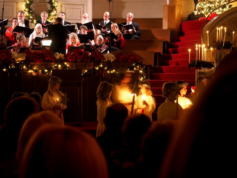 Free A festive candlelight ceremony with a choir performing at a Seattle church with holiday decorations. Stock Photo