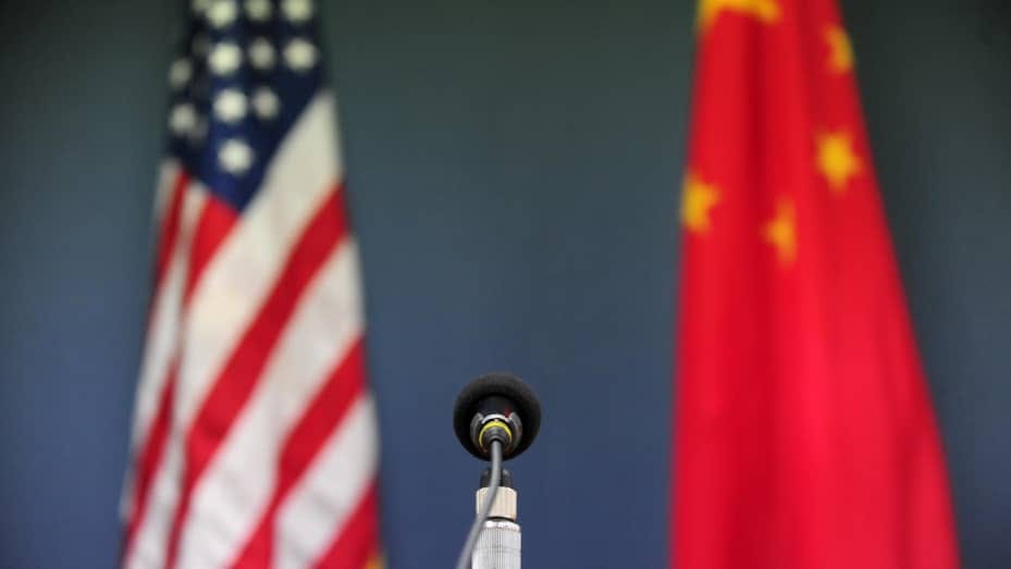 The U.S. and China flags stand behind a microphone at the U.S. Embassy in Beijing on April 9, 2009.