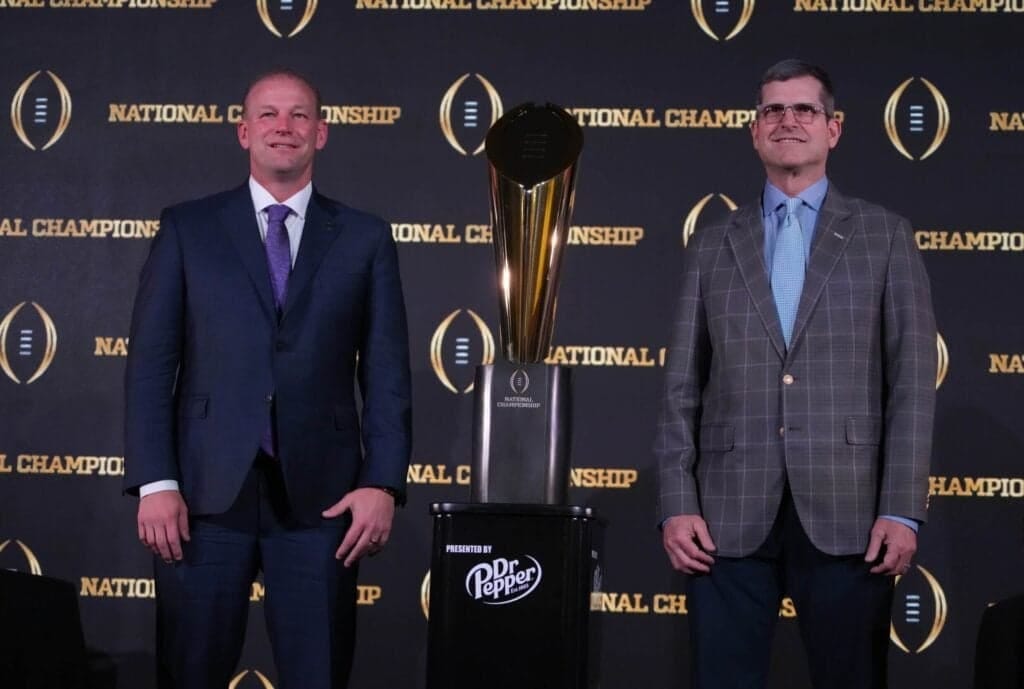Jan 7, 2024; Houston, TX, USA; Washington Huskies coach Kalen DeBoer (left) and Michigan Wolverines coach Jim Harbaugh pose with the College Football Playoff national championship trophy at the CFP National Championship Head Coaches press conference at JW Marriot Houston by the Galleria. Mandatory Credit: Kirby Lee-USA TODAY Sports