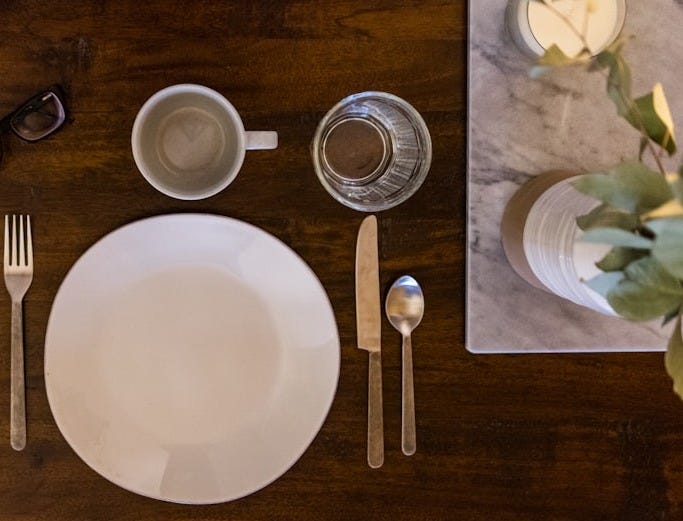 white ceramic plate on brown wooden table