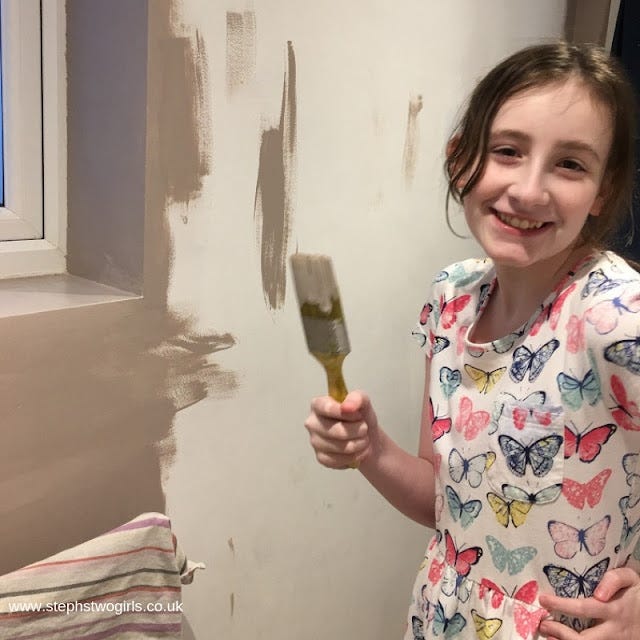Sasha with a paintbrush and a smile