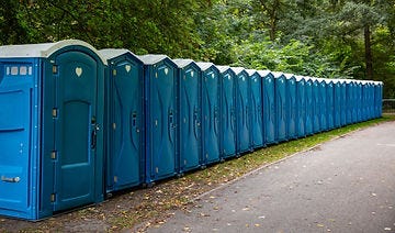 A row of about 20 porta potties