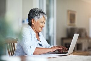 Woman smiling at her laptop