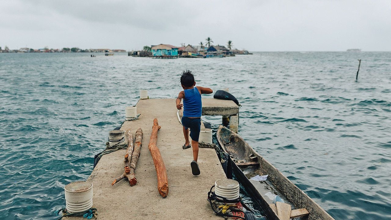 A 7-year-old plays on his familly’s dock on the island of Gardi Sugdub.
