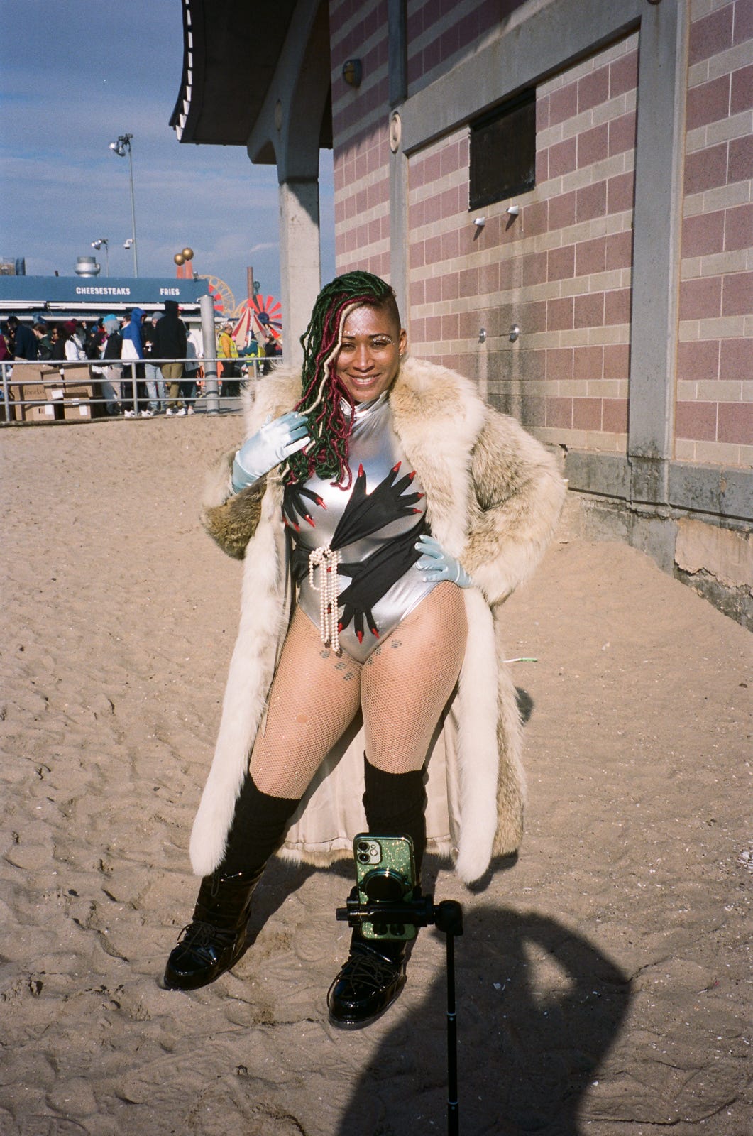 35mm color film photo of woman posing in bathing suit and fur coat