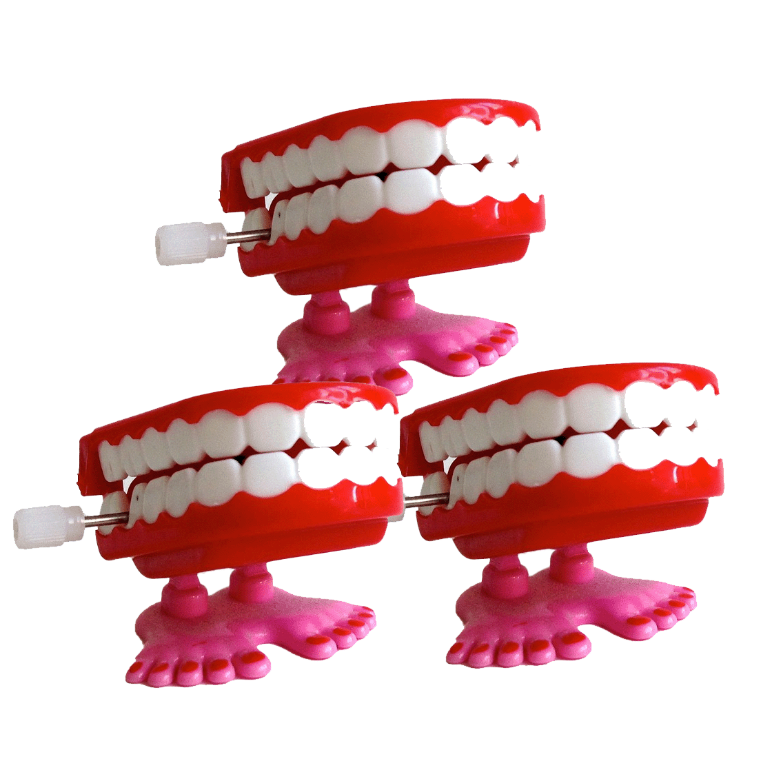 Three wind-up plastic teeth with feet stacked one on top, two on the bottom