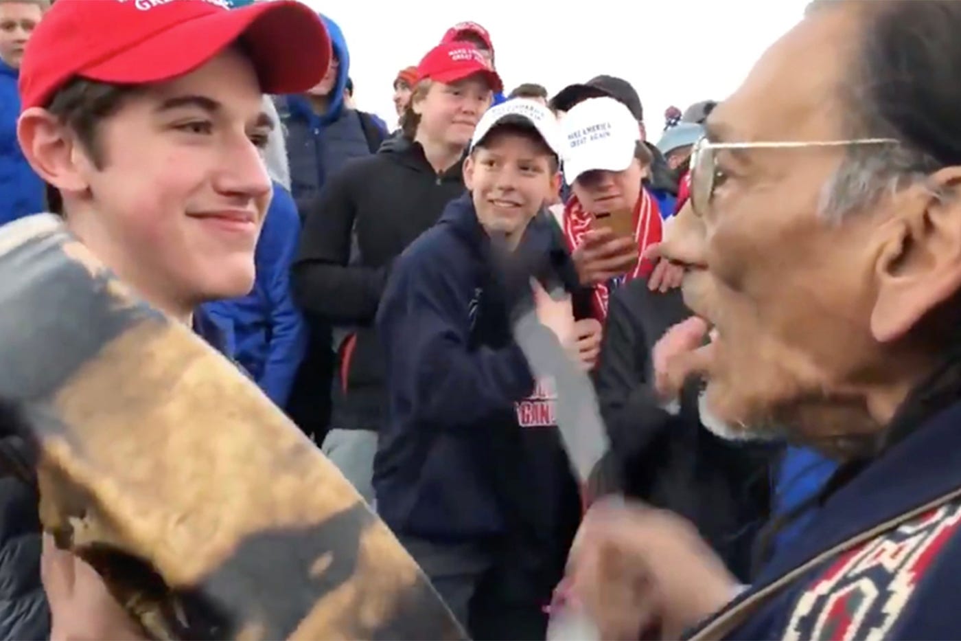 You think you can read the facial expression on the teenager in the MAGA  hat? You can't. - Northeastern Global News