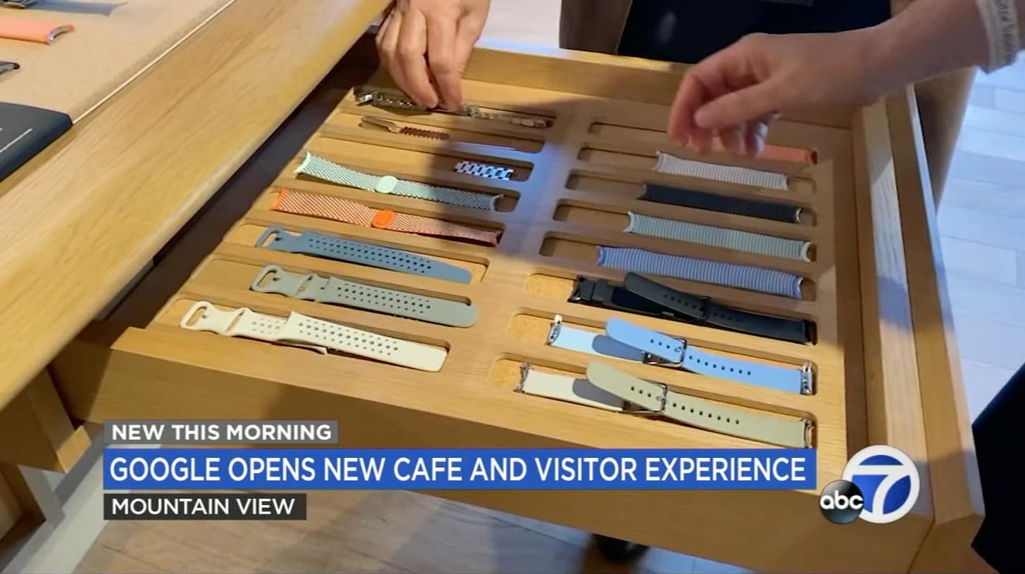 A watch band try inside a wood display table at Google Visitor Experience. The design is almost identical to the try-on table drawers found in Apple Stores.