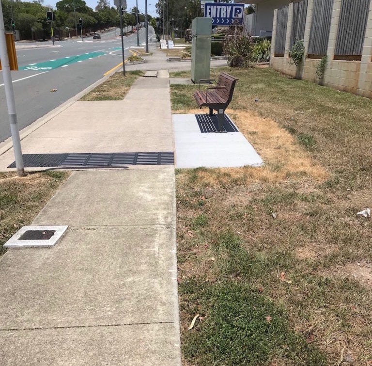 photo of bus stop beside major road