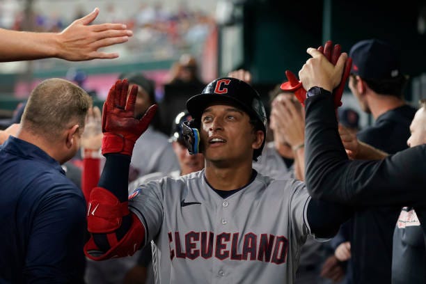 Bo Naylor of the Cleveland Guardians is congratulated by teammates after hitting a two-run home run during the third inning against the Texas Rangers...