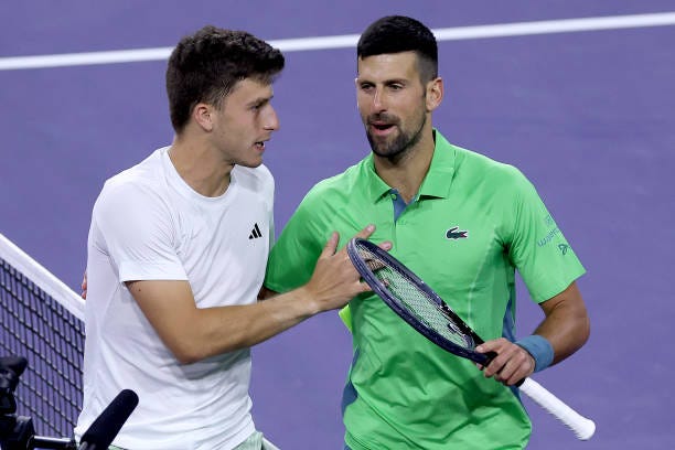 Luca Nardi of Italy is congratulated by Novak Djokovic of Serbia after their match during the BNP Paribas Open at Indian Wells Tennis Garden on March...