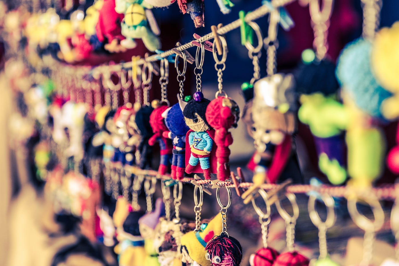 A picture of keychains hanging on rows of rope.
