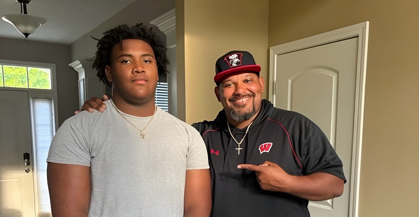 2026 recruit Arthur Scott standing next to Wisconsin Badgers defensive line coach E.J. Whitlow
