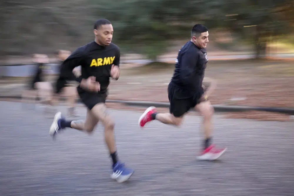 Army Staff Sgt. Daniel Murillo, right, runs up hill as part of his physical training at Ft. Bragg on Wednesday, Jan. 18, 2023, in Fayetteville, N.C. Obesity in the U.S. military surged during the pandemic, new research shows. Nearly 10,000 active duty Army soldiers became newly obese between February 2019 and June 2021, after restricted duty and limited exercise led to higher body mass scores. (AP Photo/Chris Carlson)