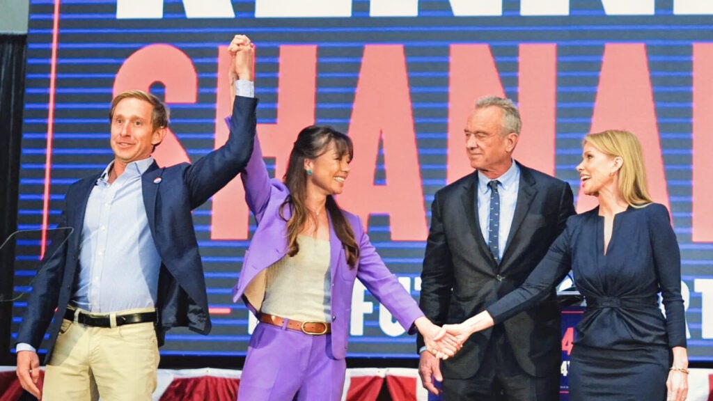 Nicole Shanahan [Center Left] joins running mate Bobby Kennedy [Center Right] while their respective spouses flank them.