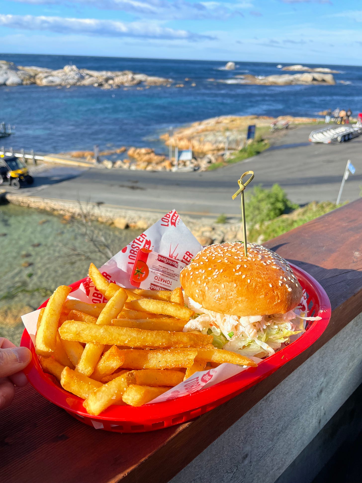 Lobster roll and chips at a water-side eatery that overlooks the sea.