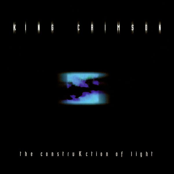 The cover for King Crimson’s THE CONSTRUKCTION OF LIGHT, which is mostly black but with an small odd image in the middle, kind of like a dental x-ray, but the gums are turquoise and the teeth are purple, and the teeth look horrible.