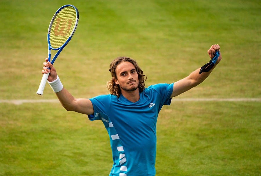 STEFANOS TSITSIPAS arms up for victory at Wimbledon 2019.